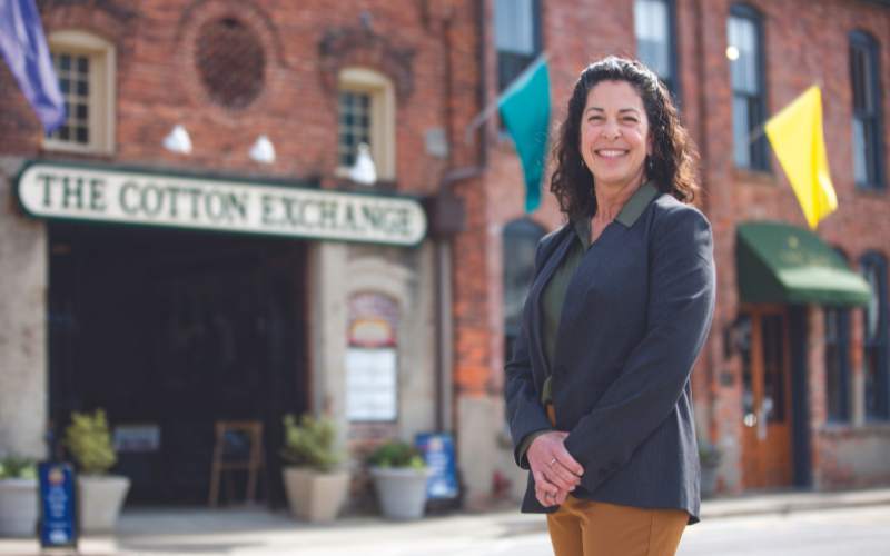 Kelli Jordan, owner of Studio Three Architects and president of the Downtown Business Alliance, stands outside The Cotton Exchange in downtown Wilmington, where upcoming potential changes could have a major impact. (Photo by Madeline Gray)